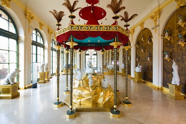 Goldener Saal mit mehreren Tierfiguren aus Porzellan